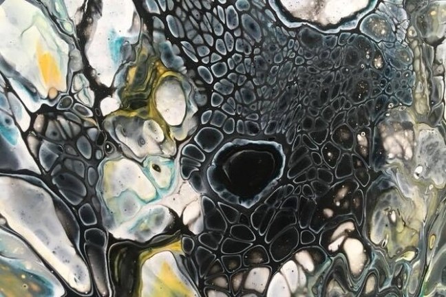 Abstract art with cells in dark hues, white, yellow, and blue accents.