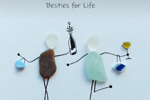 Two stick figures with sea glass bodies celebrating with drinks, captioned 'Besties for Life'.