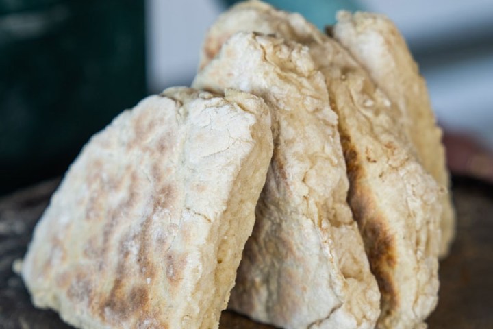 Three pieces of rustic soda bread leaning against each other.