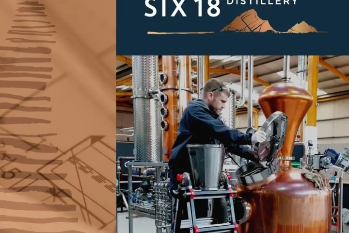 Person working at Skellig Six18 Distillery with copper equipment and ladder.
