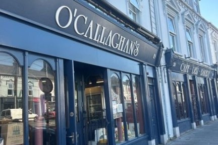 Street view of O'Callaghan's storefront with blue facade.